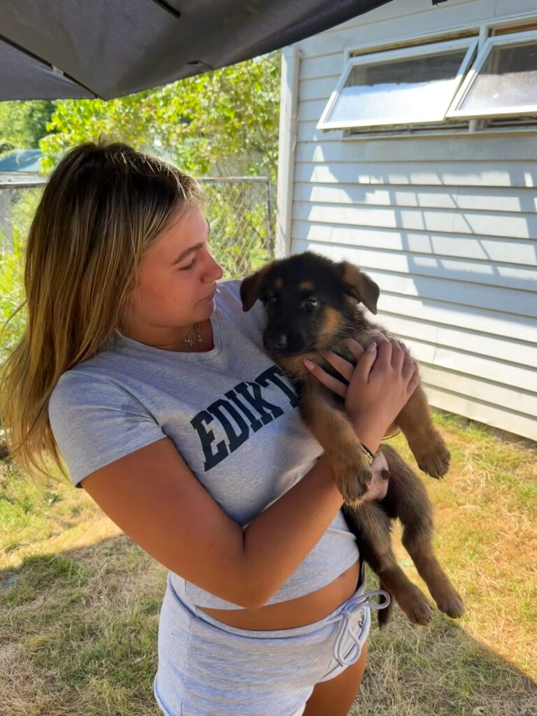 Woman holding a German Shepherd puppy at Metro K9 Academy, Bernardsville NJ